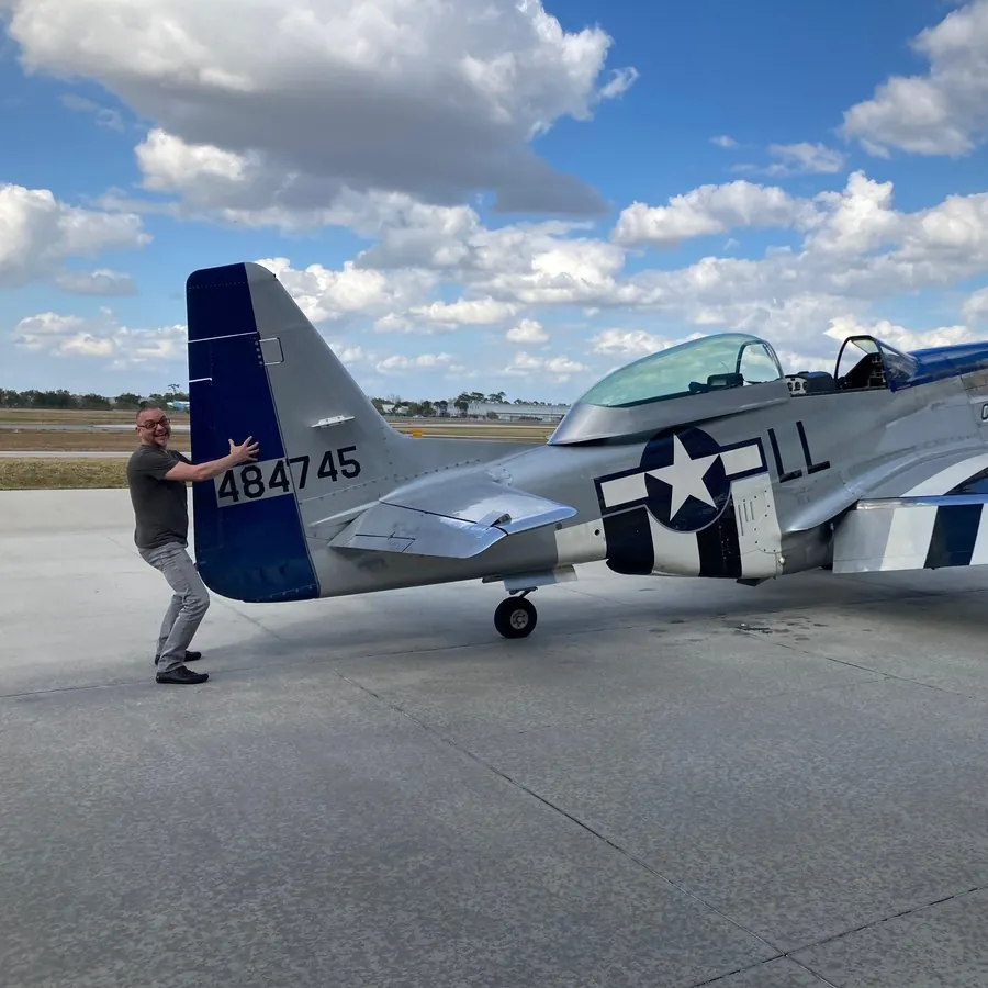 Russ Laggan with a P-51 on the ramp
